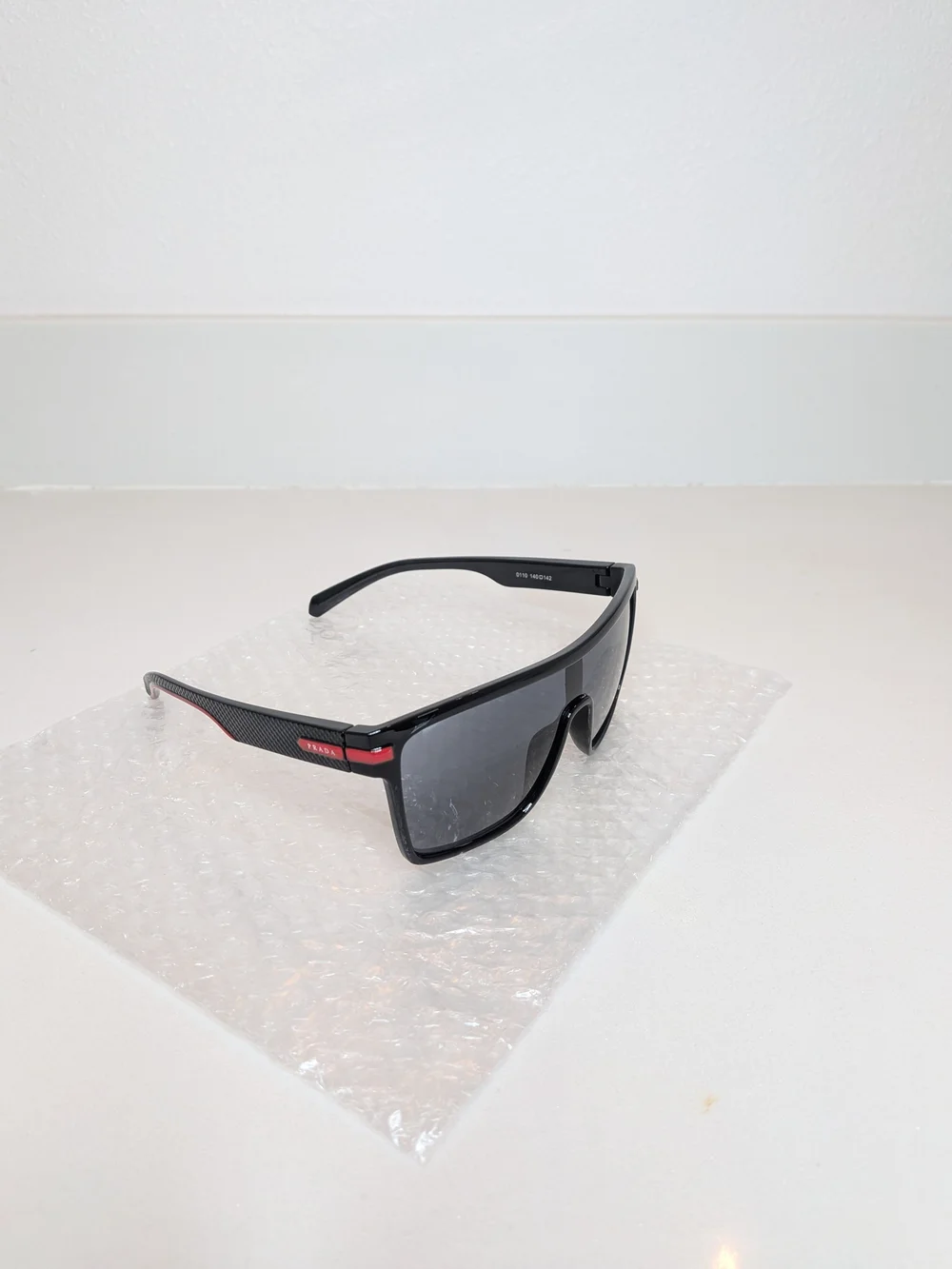 Prada Men’s Black Shield Sunglasses Red Logo Sport